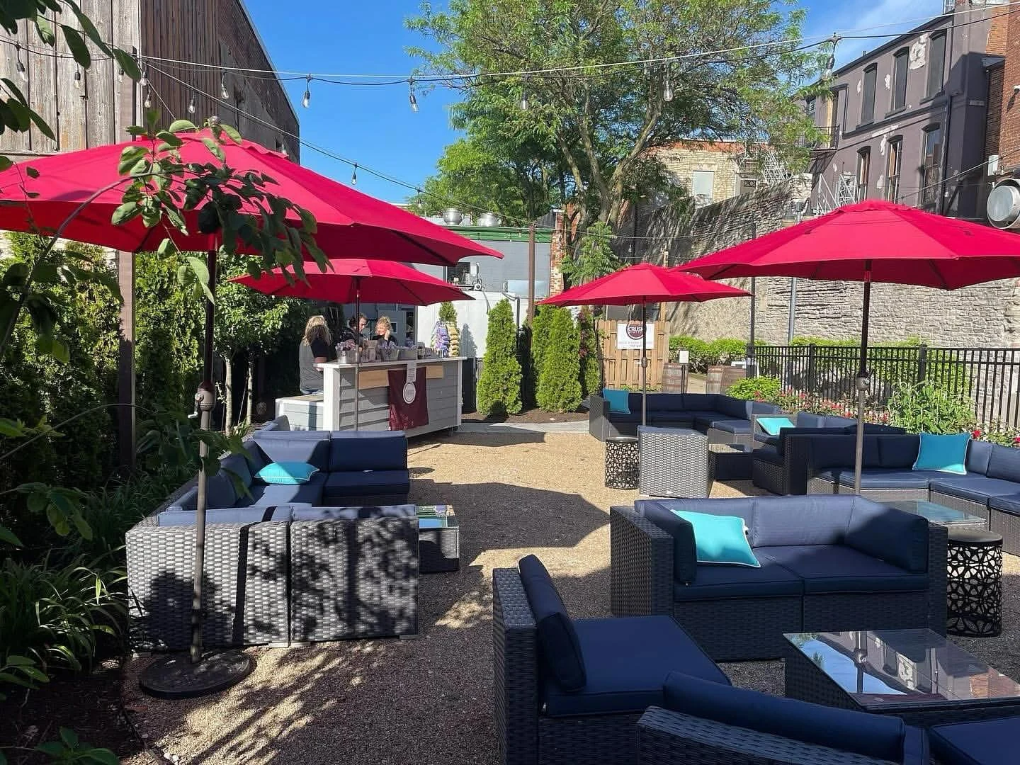 Crush Wine Garden with lounge seating and red umbrellas