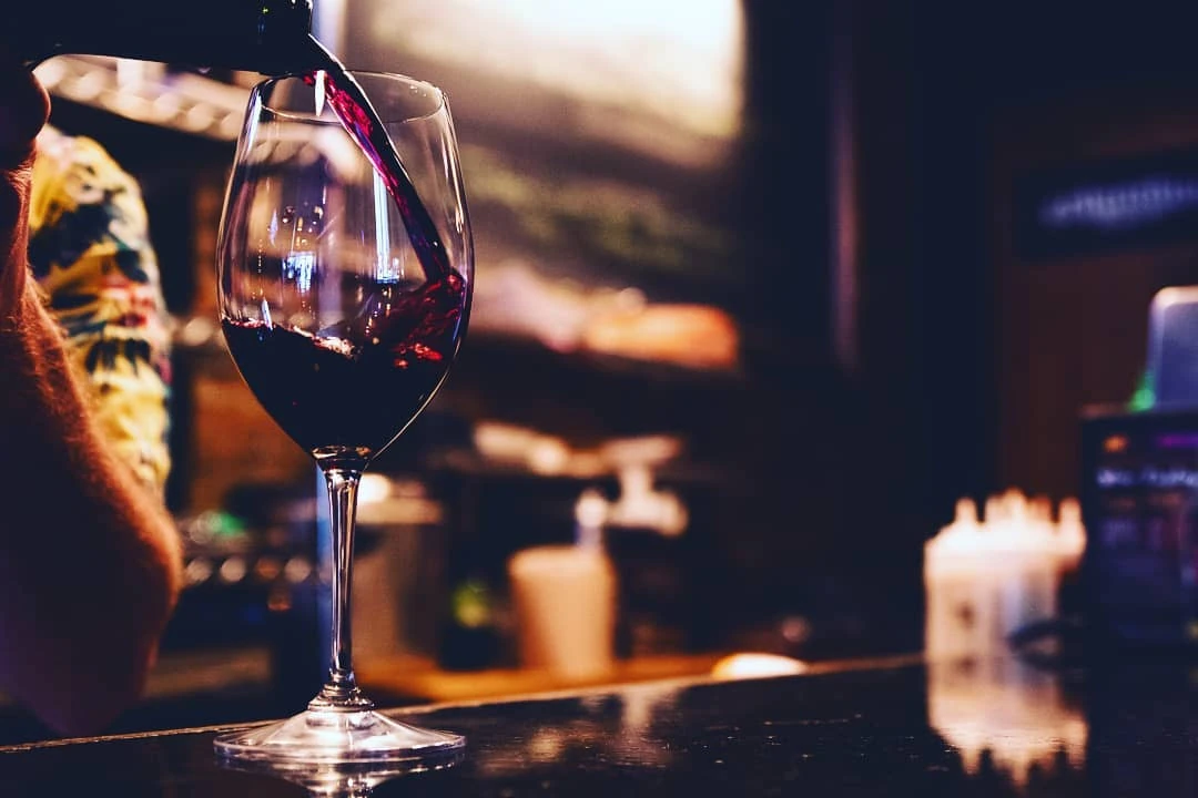 Red wine being poured at the bar at Crush Wine Bar