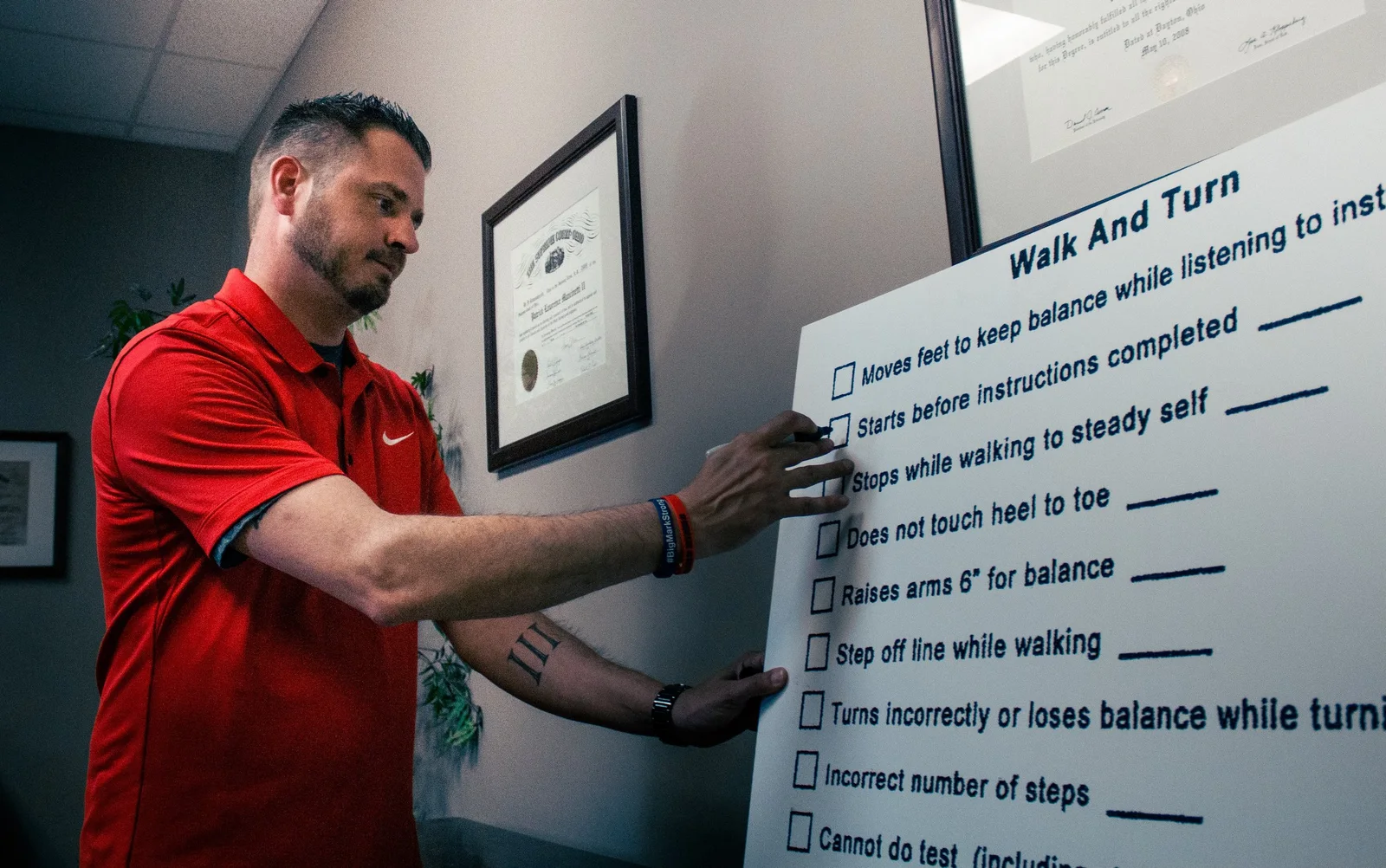 Patrick Mancinetti II with a field-sobriety demonstration board, from the firm’s published biography